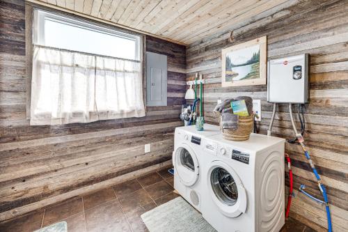 a washer and dryer in a room with wooden walls at Rustic Cabin in Peyton Near Hiking Trails! in Peyton