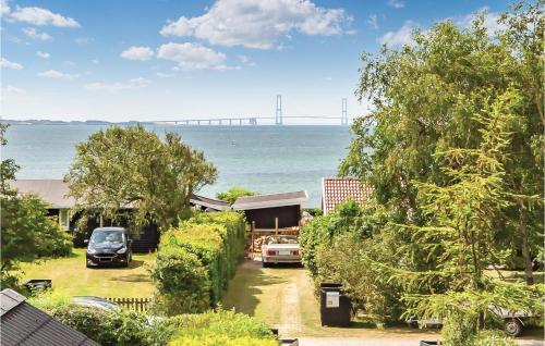a house with a car parked in front of the ocean at Awesome Home In Slagelse With Wifi in Slagelse