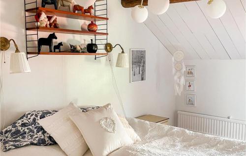 a bedroom with a bed and shelves on the wall at Stunning Home In Västervik With Kitchen in Västervik