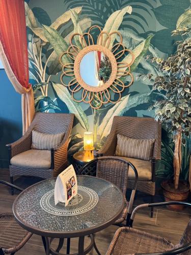 a room with a table and chairs and a mirror at GreenTree Inn & Suites Los Angeles - Alhambra - Pasadena in Alhambra