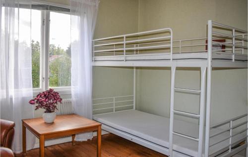 a room with two bunk beds and a table at 2 Bedroom Gorgeous Home In Alstermo in Alstermo