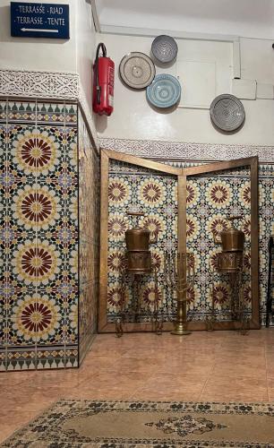 a room with tiles on the wall and a fire hydrant at Hotel Riad Fantasia in Marrakech