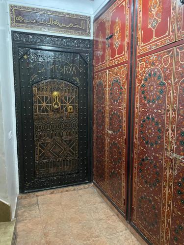 a room with a large wooden door on a wall at Hotel Riad Fantasia in Marrakech