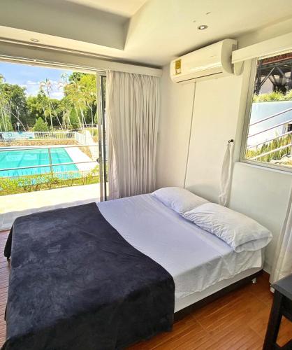 a bedroom with a bed with a view of a pool at Finca Hotel Santaleja in La Tebaida