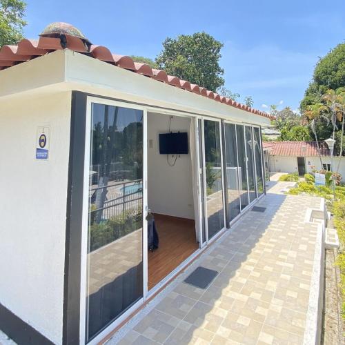 a house with glass doors and a balcony at Finca Hotel Santaleja in La Tebaida
