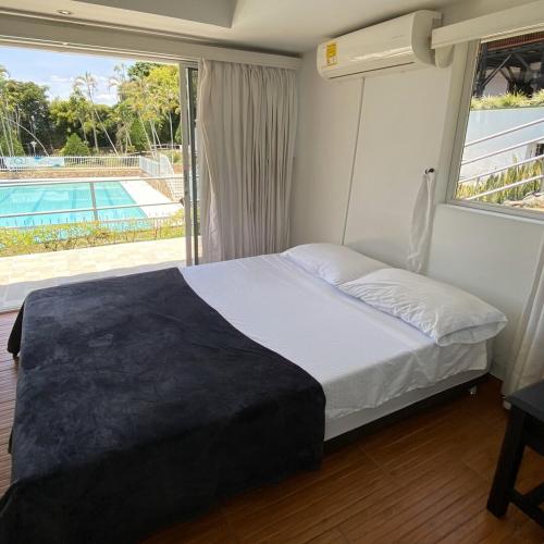 a bedroom with a bed with a view of a pool at Finca Hotel Santaleja in La Tebaida