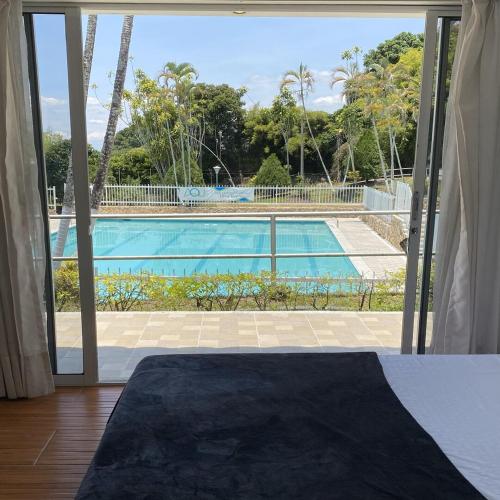 a view of a swimming pool through a sliding glass door at Finca Hotel Santaleja in La Tebaida