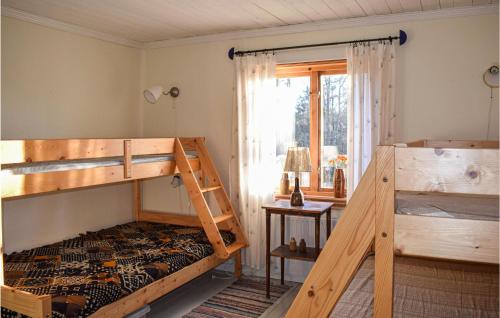 a bedroom with two bunk beds and a window at 2 Bedroom Pet Friendly Home In Burseryd in Sjötofta
