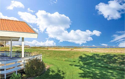 a house with a view of a field and the ocean at Holiday Home Juelsminde With A Fireplace 09 in Juelsminde