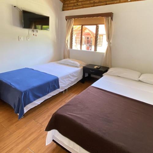 a room with two beds and a window in it at Finca Hotel Santaleja in La Tebaida