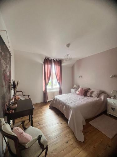 a bedroom with a bed and a desk and a window at Maison Cosy Bord de Mer in Dives-sur-Mer