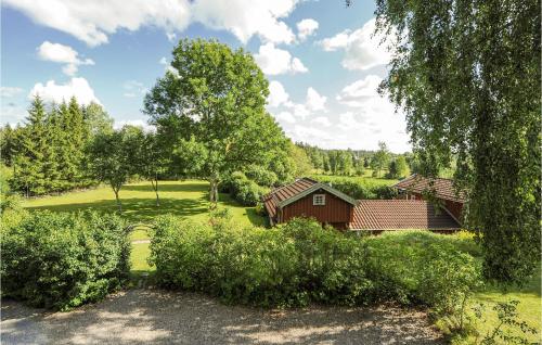 a view of a house and trees and bushes at 3 Bedroom Cozy Home In Hillared in Hillared