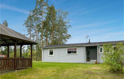 a white house with a porch and a yard at 3 Bedroom Nice Home In Högsby in Högsby