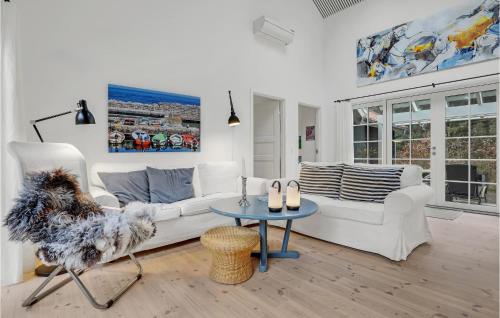 a living room with a white couch and a table at 4 Bedroom Stunning Home In Nexø in Neksø