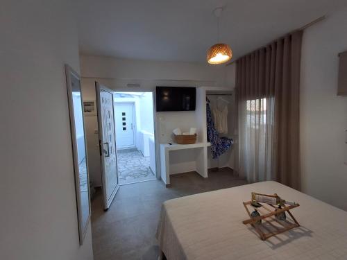 a bedroom with a bed and a hallway with a bathroom at Aegean Whisper in Masouri
