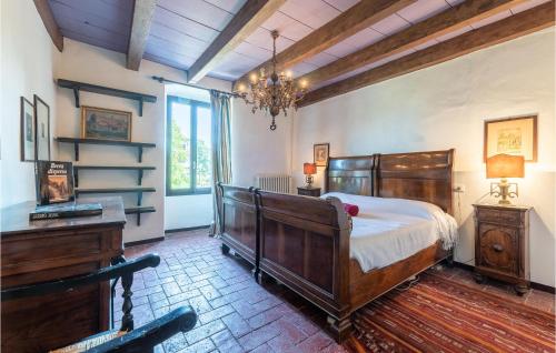 a bedroom with a large wooden bed and a dresser at Pet Friendly Home In Ponti Sul Mincio in Ponti Sul Mincio