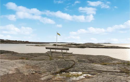 a picnic table sitting on the beach near the water at Amazing Apartment In Åsa With Kitchen in Åsa