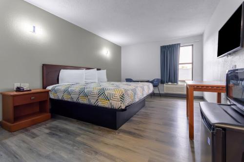 a hotel room with a bed and a desk at Motel 6 - Franklin, OH in Franklin