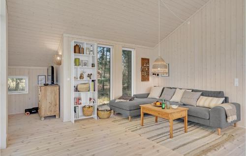 a living room with a couch and a table at Stunning Home In Sjællands Odde in Yderby