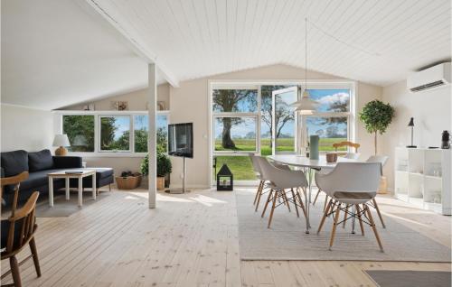 a living room and dining room with a table and chairs at Nice Home In Juelsminde With Kitchen in Juelsminde