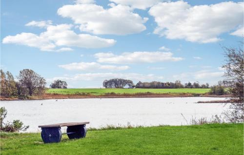 a bench sitting next to a large body of water at Cozy Home In Malling With Wifi in Malling