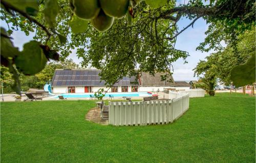 a yard with a fence and a swimming pool at Awesome Apartment In Allinge With Wifi in Allinge