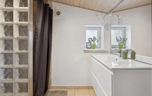 a bathroom with white walls and a sink and a mirror at Stunning Home In Broager With Wifi in Broager