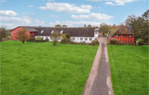 a green field with houses and a dirt road at Amazing Apartment In Faaborg With Wifi in Faaborg