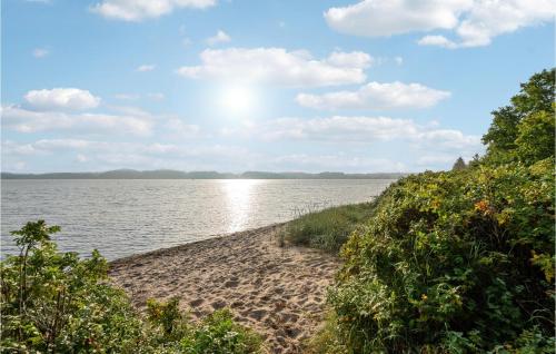 a sandy beach next to a body of water at 2 Bedroom Gorgeous Home In Højslev in Højslev