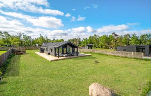 a small house in a field with a fence at Nice Home In Kalundborg With Wifi in Kalundborg