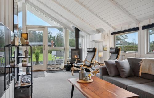 a living room with a couch and a table at Amazing Home In Tarm With Wifi in Tarm