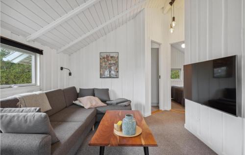 a living room with a couch and a table at Amazing Home In Tarm With Wifi in Tarm