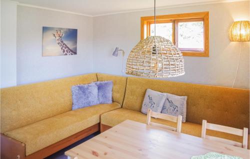 a living room with a couch and a table at Holiday Home Bosebyn Nordfalla Gunnarskog in Gunnarskog