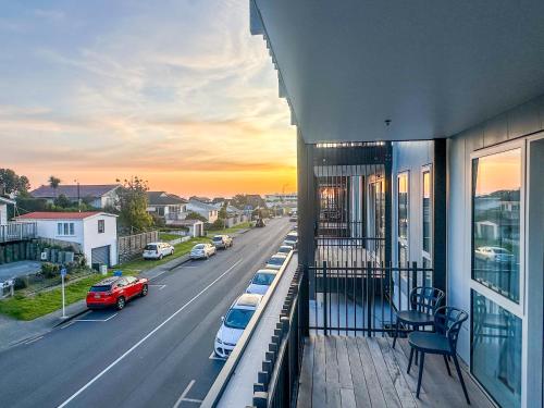 a balcony of a building with a view of a street at Modern 3Bdr 2bath Apartment Beach Golf Shops Relax in Paraparaumu Beach