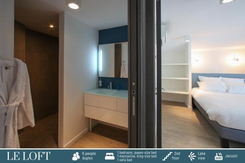 a bedroom with a bed and a bathroom with a sink at Cote Ouest in Sévrier