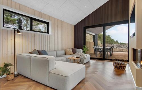 a living room with a couch and a table at Cozy Home In Tarm With Sauna in Tarm