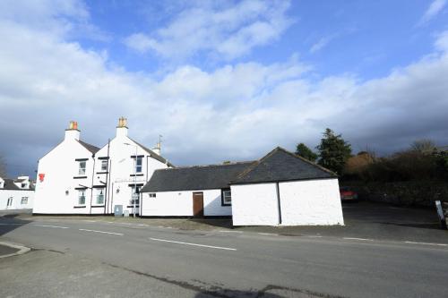 a white house on the side of a street at Star Hotel in Kirkcudbright