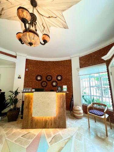 a large living room with a table and a chandelier at Charme 64 Hotel Boutique in Cartagena de Indias