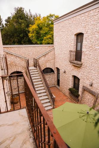 a staircase with a green umbrella next to a building at Hotel Casa Mexicana in Mineral de Pozos