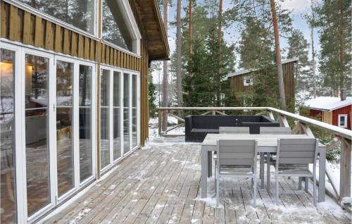 a deck with a table and chairs on a house at 2 Bedroom Gorgeous Home In Klässbol in Klässbol