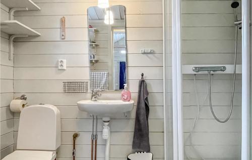 a bathroom with a sink and a toilet and a mirror at 2 Bedroom Gorgeous Home In Klässbol in Klässbol