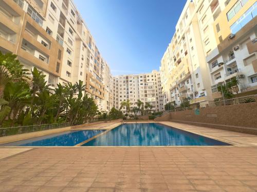 a swimming pool in the middle of some buildings at YOUR HOME in Agadir