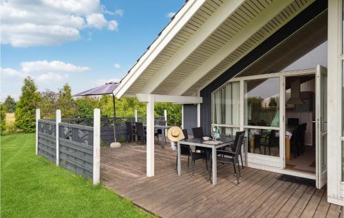 a patio with a table on a deck at Four-Bedroom Holiday Home In Sydals in Skovbyballe