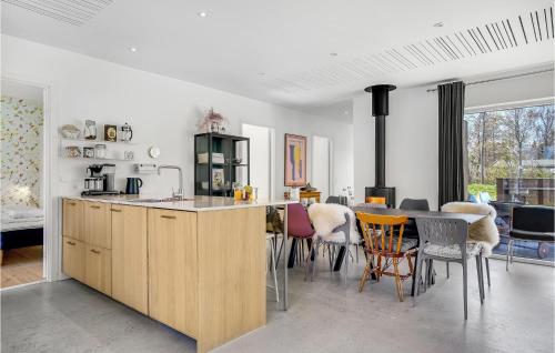 a kitchen and dining room with a table and chairs at Beautiful Home In Sjællands Odde in Yderby
