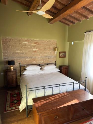 a bedroom with a bed and a brick wall at Sacro e Profano Albania in Zikxhafaj