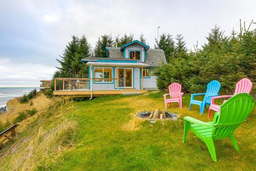 four chairs in front of a house on the beach at Deck and Panoramic Views Bayfront House in Homer! in Homer