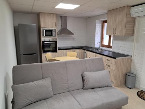 a living room with a couch in a kitchen at M&M Arboleas in Arboleas
