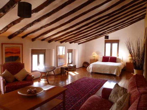 a large living room with a bed and a couch at Hotel Casa Pedro Barrera in Almudema