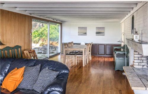 a living room with a leather couch and a table at Five-Bedroom Holiday Home In Mandal in Mandal