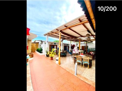 a patio with a roof with a table and chairs at Zurisadai in Puerto Ayora